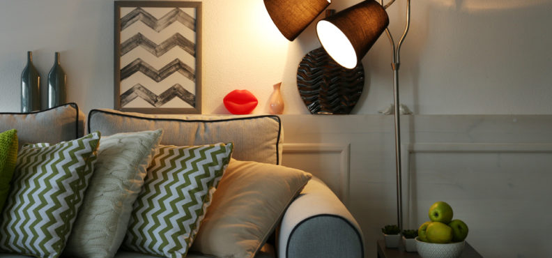 A brightly lit lamp in a beautifully furnished home. Here are the benefits a lamp can have on your house.