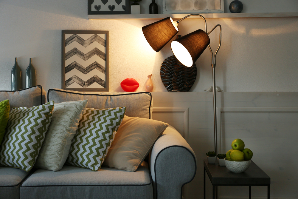 A brightly lit lamp in a beautifully furnished home. Here are the benefits a lamp can have on your house.