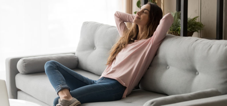 Serene,Young,Woman,Pretty,Relaxing,On,Couch,In,Living,Room.