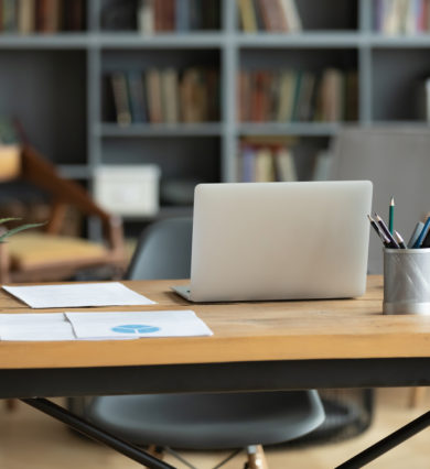 wooden, desk, with, laptop, lamp, papers, and, plant