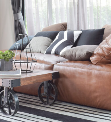 leather, couch, with, wooden, table, in, front, of, it