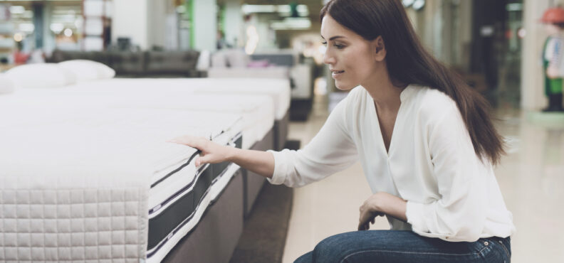 woman, choosing, a, mattress, in, a, store