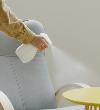 woman, using, spray, to, clean, chair, at, home